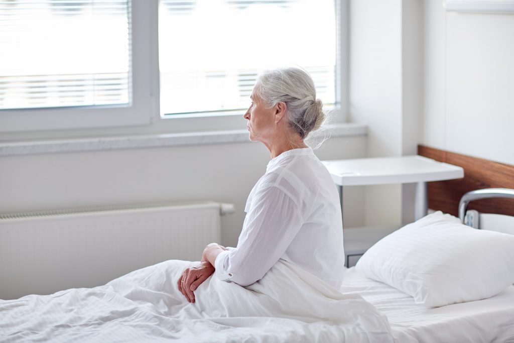 Elderly woman in hospital bed